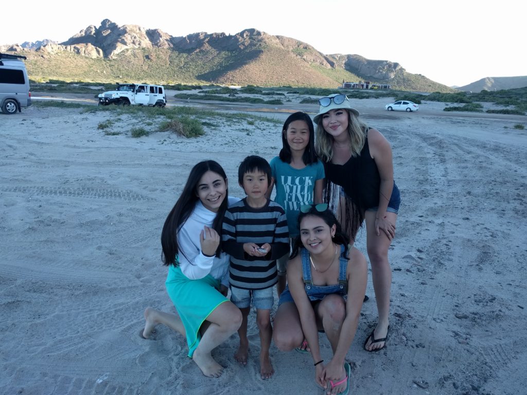 Cute Mexican girls helping get our van out of the sand.